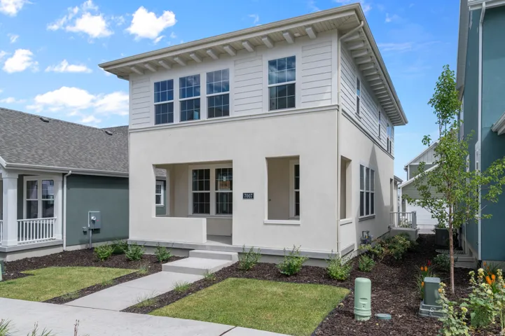 Contemporary stucco and siding exterior with multiple windows