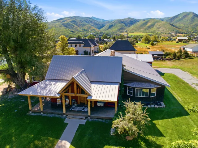 Metal roof construction with a covered front porch featuring exposed timber framing