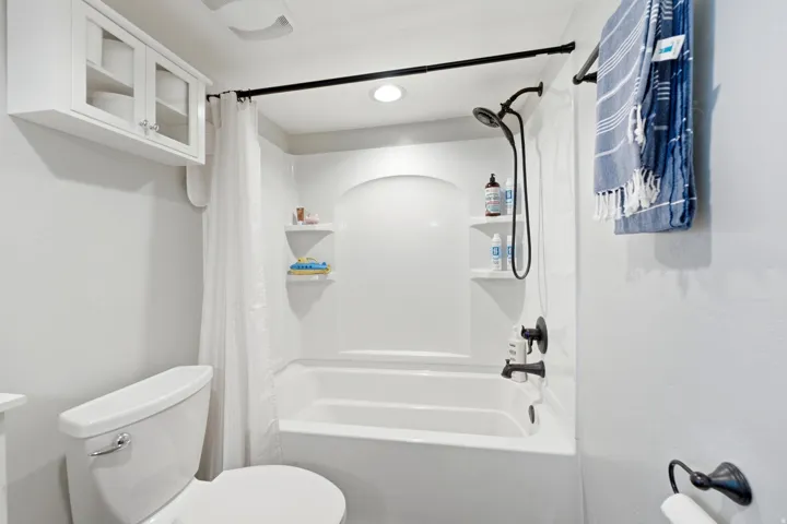 White tub/shower combination with black fixtures