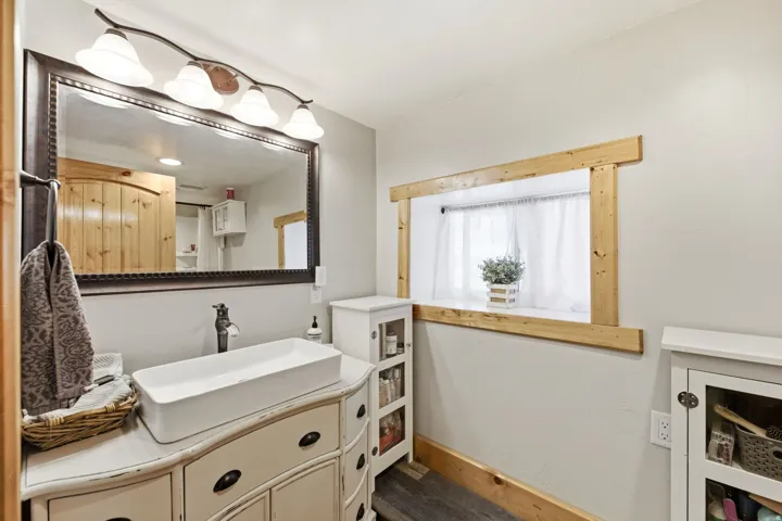 White rectangular vessel sink with dark bronze faucet