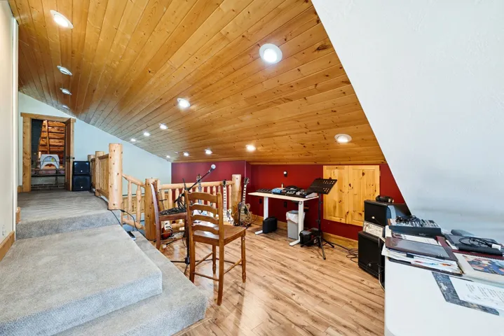 Sloped wood-finish ceiling with recessed lighting