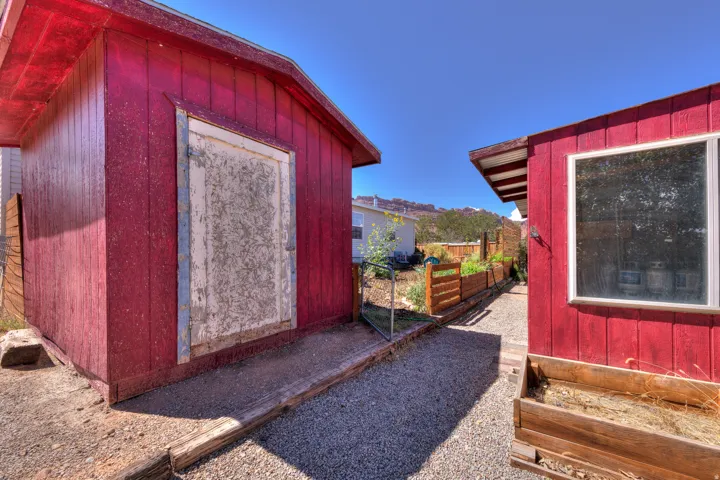Red-sided outbuilding with a single window