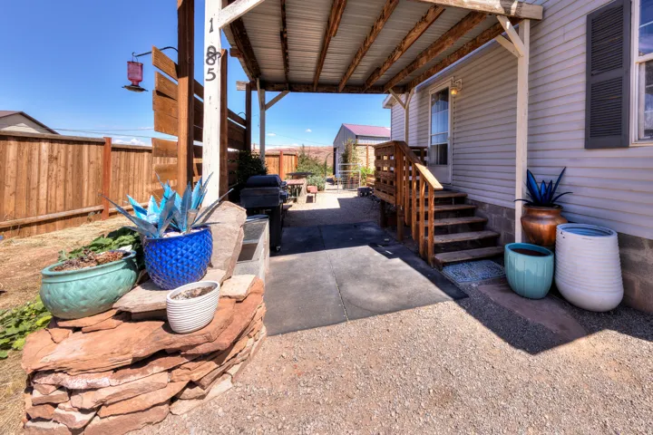 Covered porch entry with wood steps and railing