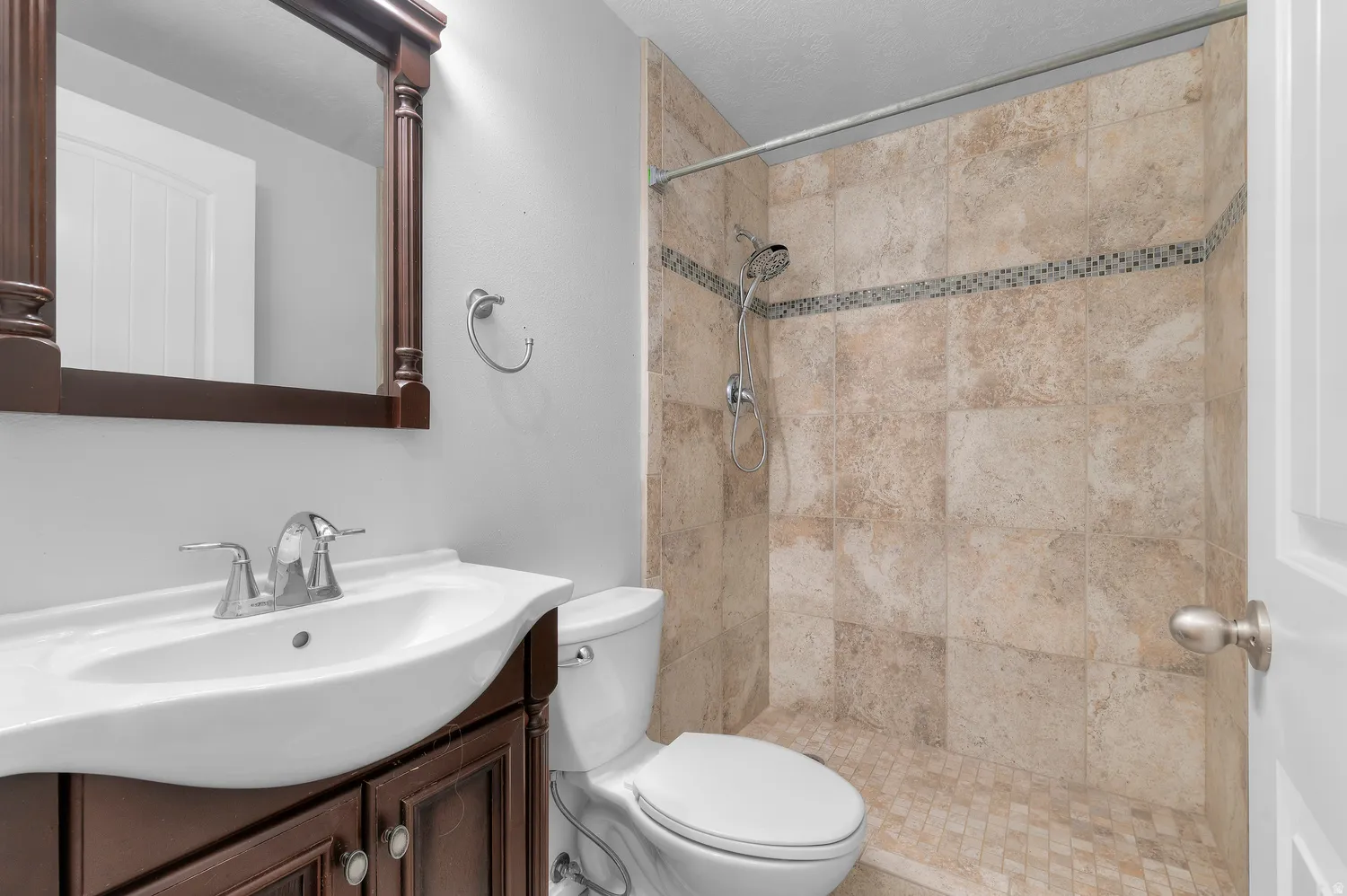 Wood-finish vanity with an integrated sink and chrome faucet