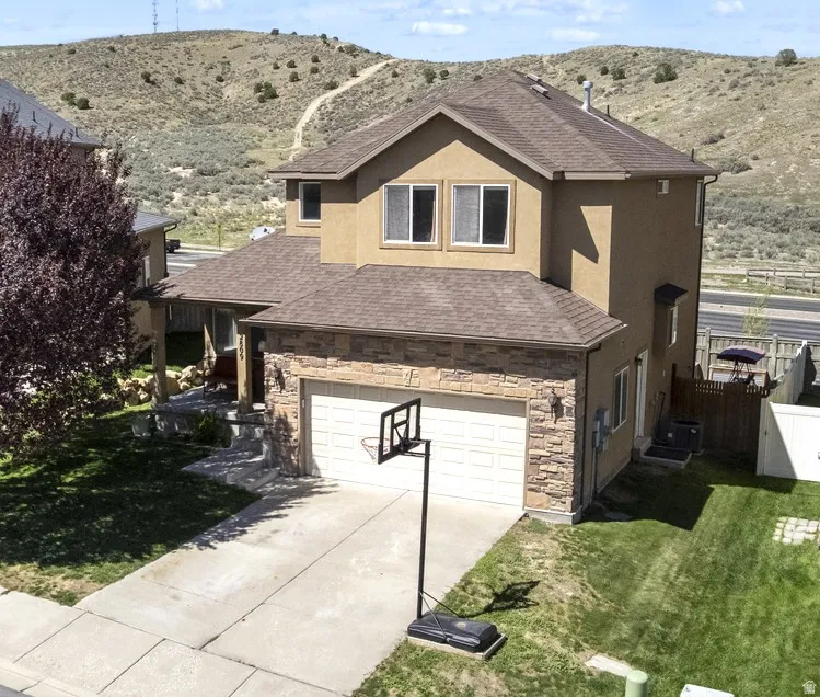Two-story stucco exterior with stone accents