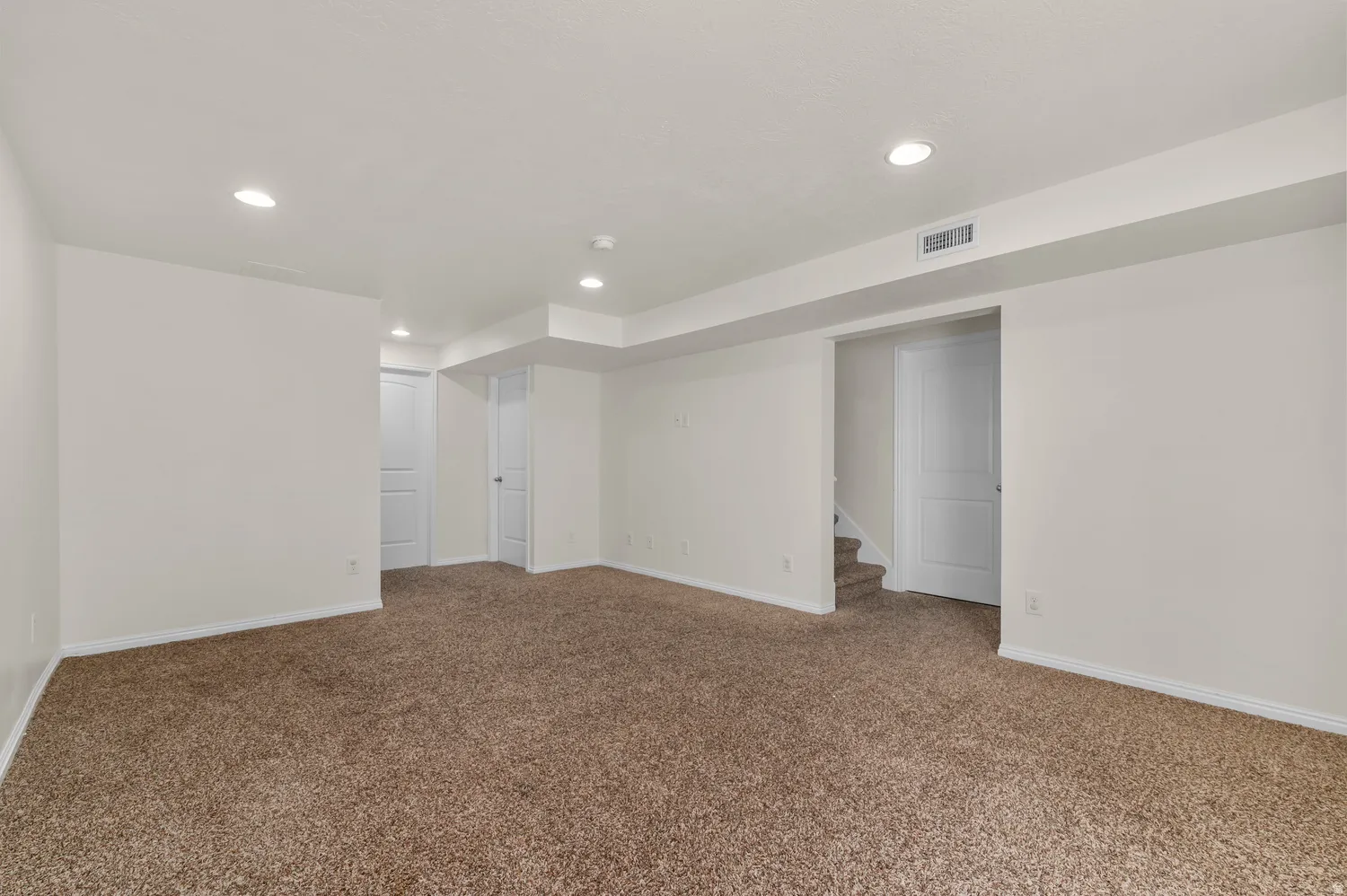 Expansive room featuring recessed lighting, plush carpet flooring, white painted walls, and white trim