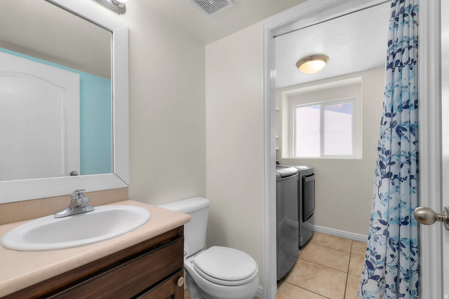Vanity with a single basin sink and a wood-finish cabinet