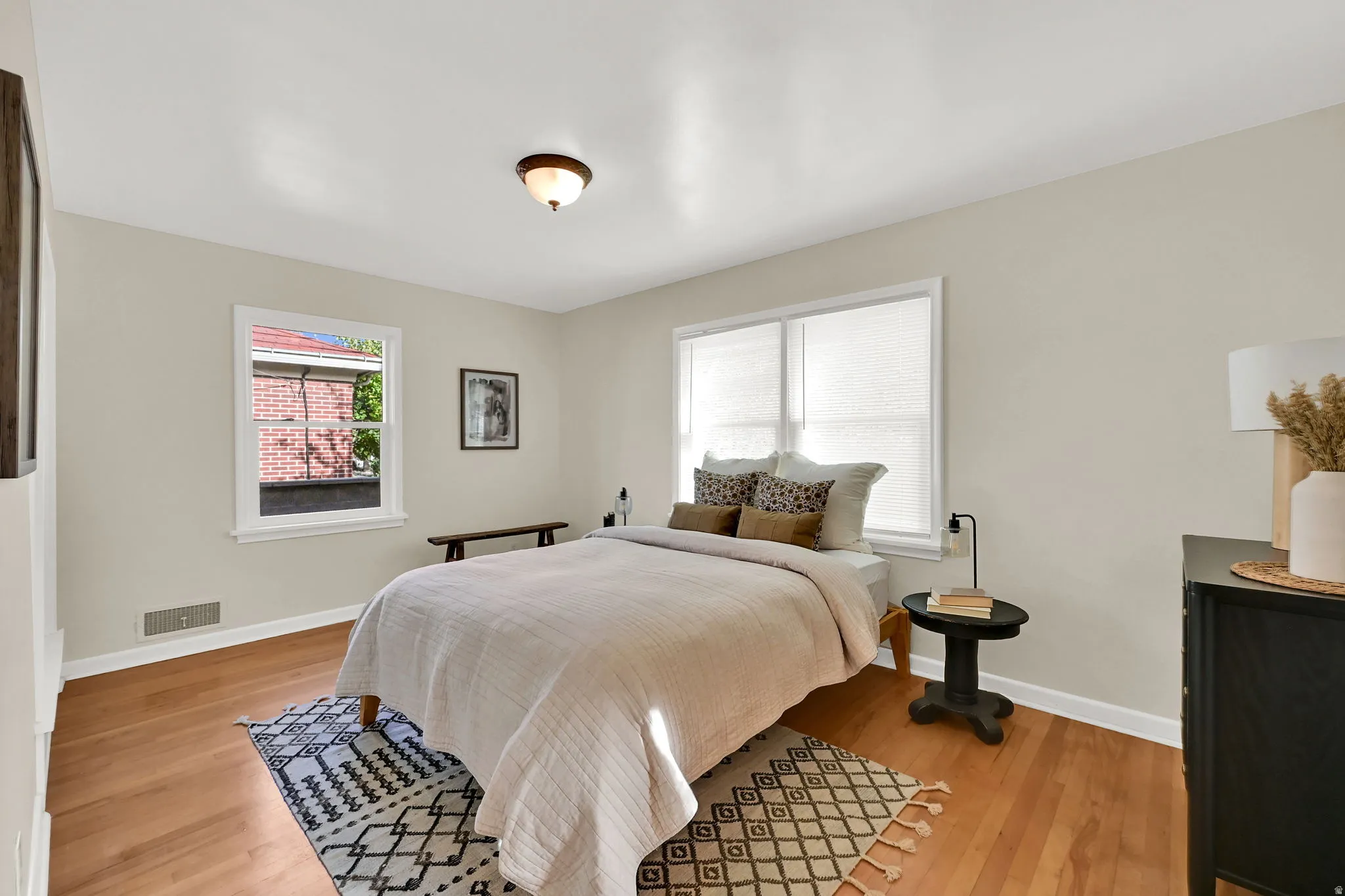 Recessed lighting, wood-finish flooring, and white trim
