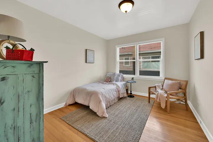 Hardwood flooring, painted walls, and a ceiling-mounted light fixture