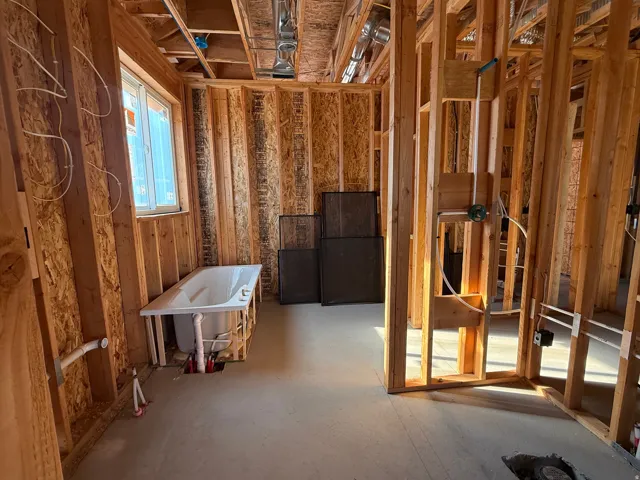 Framed interior construction with a window and a bathtub