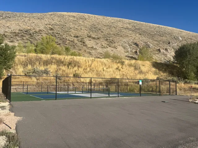Fenced hardcourt with a green and blue surface