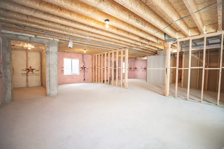 Unfinished basement with two cold storage areas, potential for large family/game room, full bathroom, kitchenette and two bedrooms.