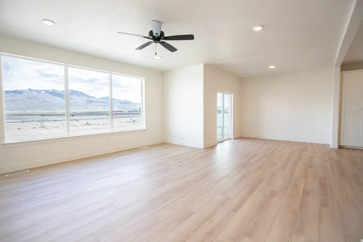 Large family room and open dining area with picture windows, 9' ceiling ann ceiling fan.