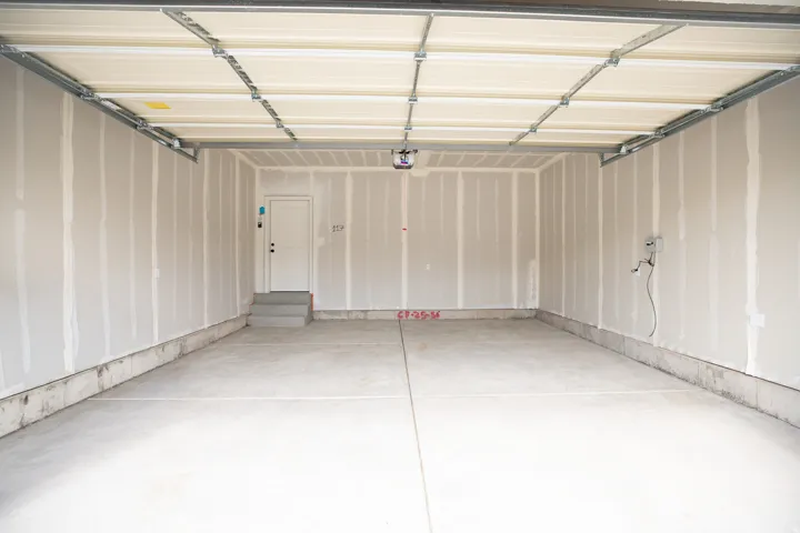 Two-car garage with taped finish.