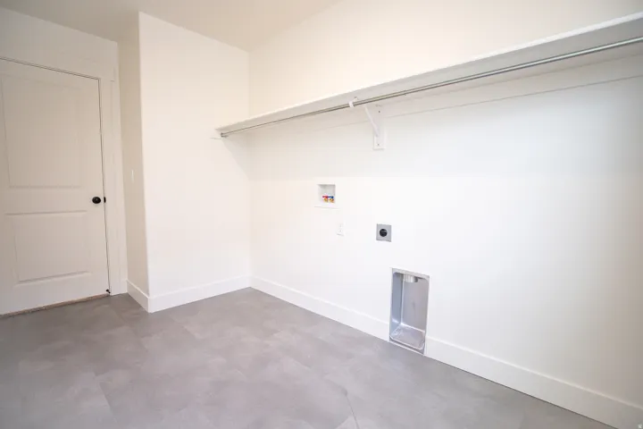 Full-size, dedicated laundry room with natural light and washer/dryer hookups.