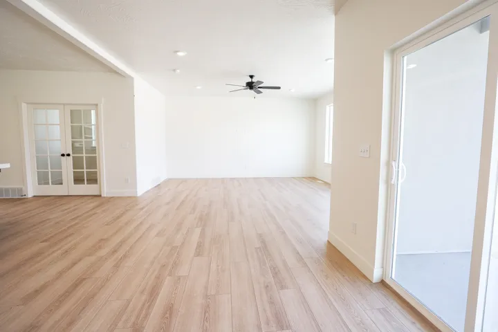 View of family room and den from open dining area adjacent to covered rear porch and kitchen.