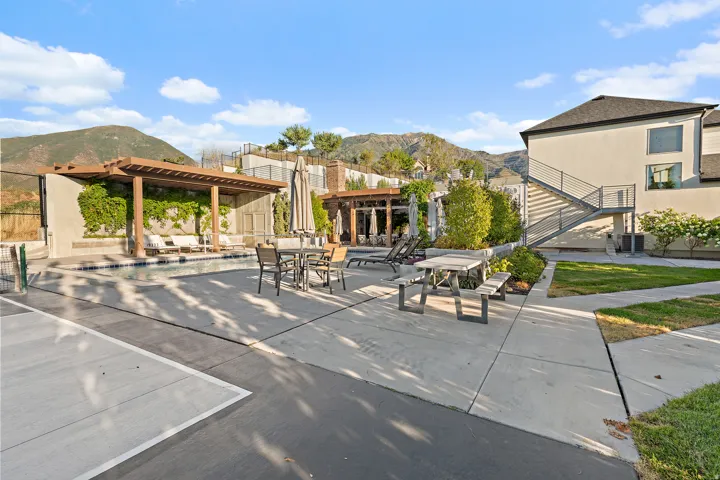 Outdoor pool with integrated pergola and lounge area