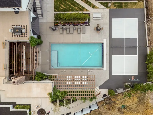 Outdoor pool, full-size sports court, multiple pergolas, concrete patio, and mature landscaping