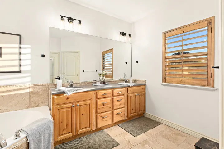 Dual vanity with wood-finish cabinetry and integrated sinks