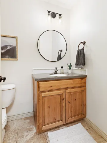 Light wood-finish vanity with a built-in sink and dark countertop