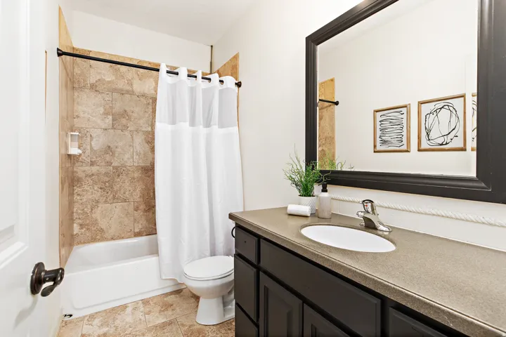 Full bathroom with a tub/shower combination featuring tiled walls
