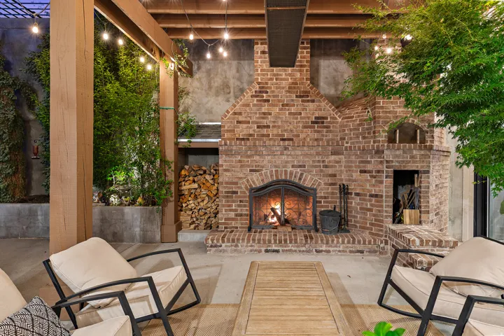 Outdoor brick fireplace with arched firebox