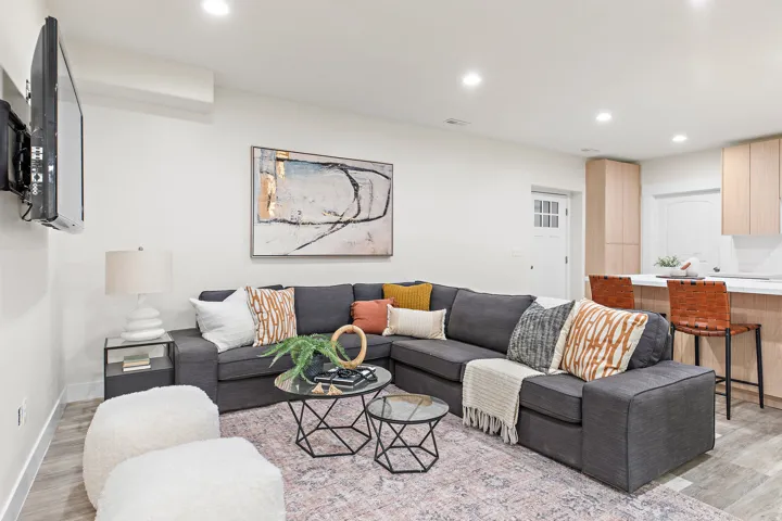 Recessed lighting, wood-finish flooring, white walls, built-in kitchen cabinetry, and a white kitchen countertop