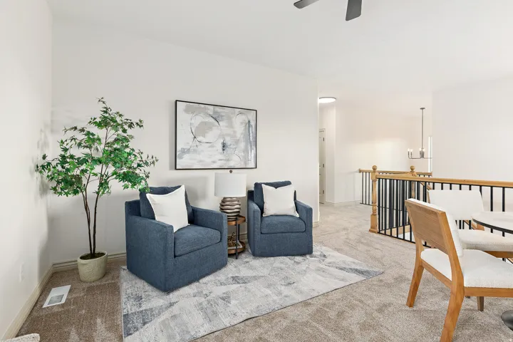 Carpeted upper-level space featuring a contemporary railing with wood and black metal spindles