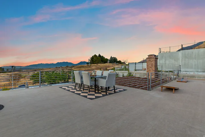 Expansive outdoor terrace featuring concrete paving and a cable railing system