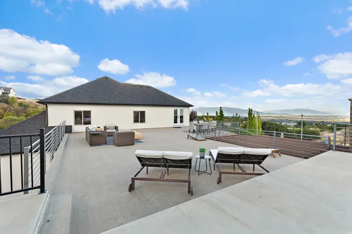 Expansive outdoor patio with metal railing, offering broad scenery