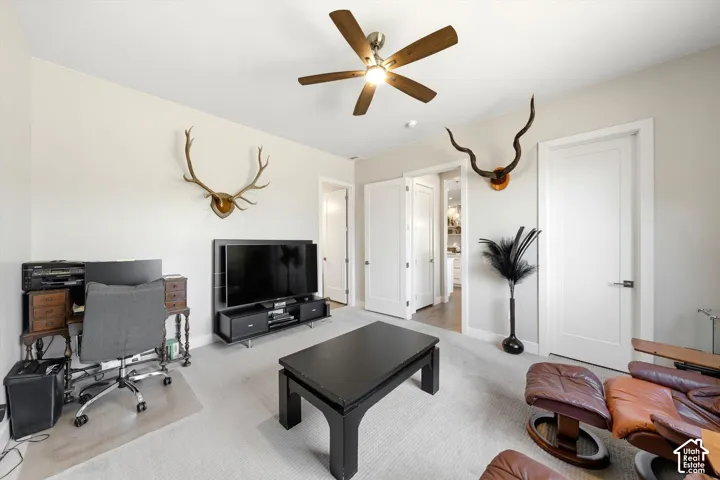 Recessed lighting, ceiling fan with integrated light, multiple white panel doors, light-toned wall paint, and light-toned carpet flooring