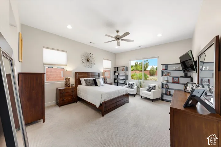 Spacious room featuring vaulted ceilings, recessed lighting, a ceiling fan, and light-toned carpeting