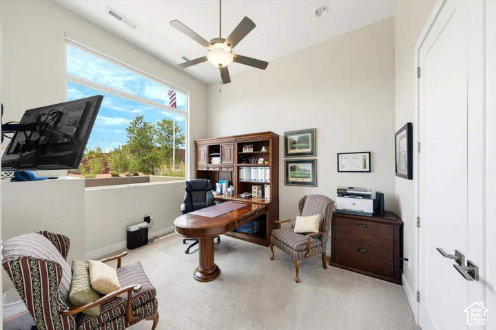 Carpeted room with high ceilings, recessed lighting, and a ceiling fan