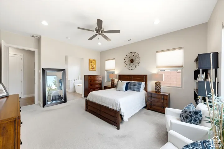 Recessed lighting, ceiling fan, multiple windows with blinds, and light-toned carpeting