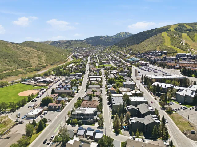 Expansive mountain setting with a distant ski resort and surrounding green hills