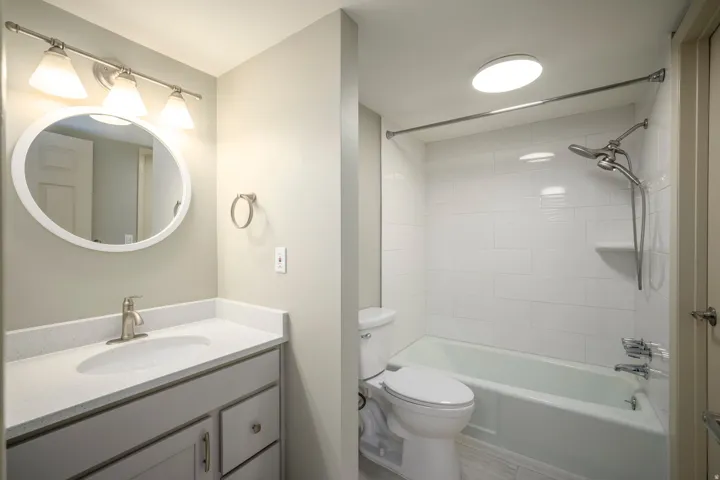 Vanity with a solid surface countertop, undermount sink, and brushed nickel faucet