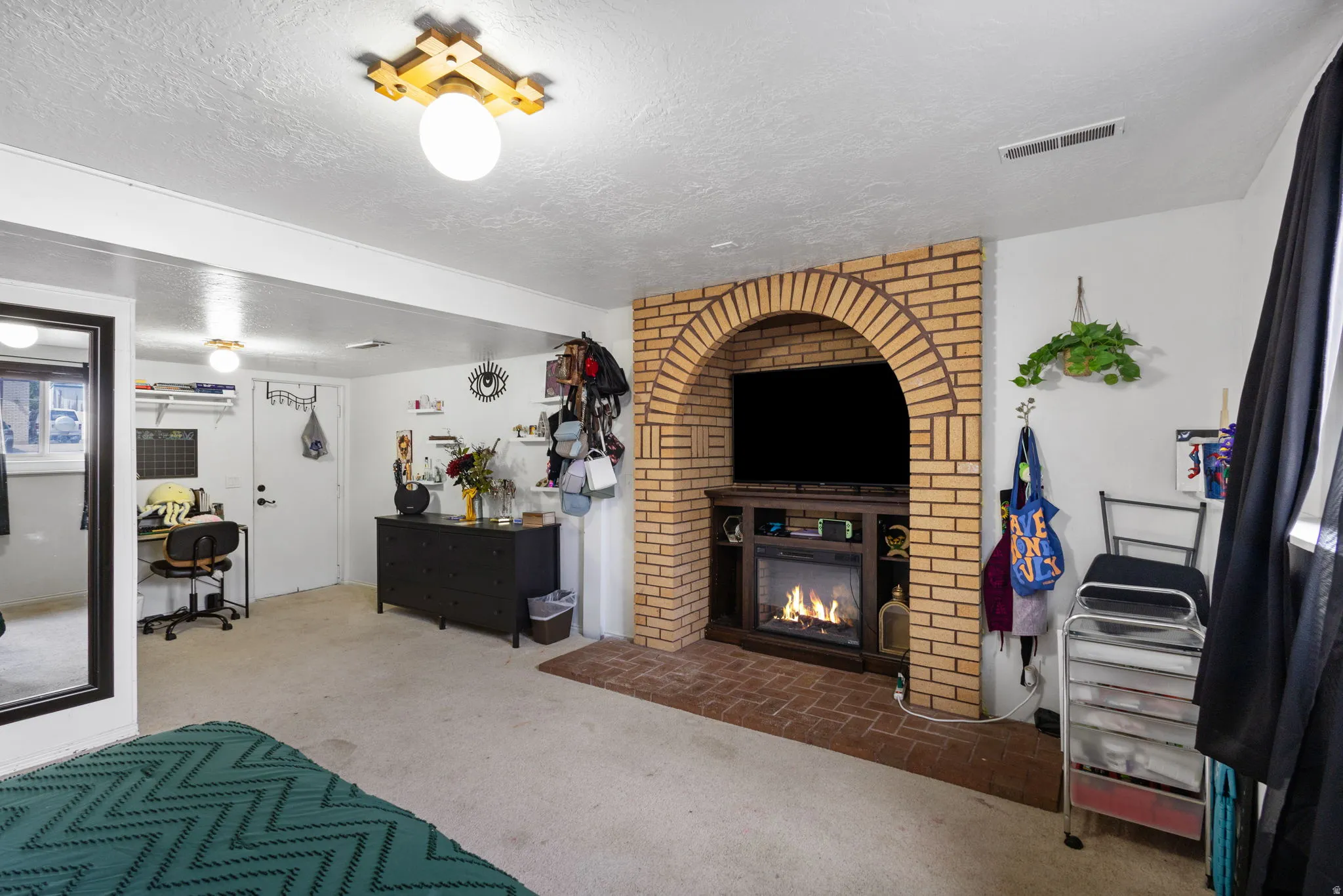 Brick fireplace with an arched opening and integrated media console