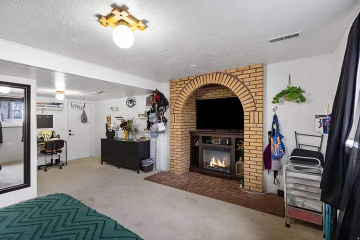Brick fireplace with an arched opening and integrated media console