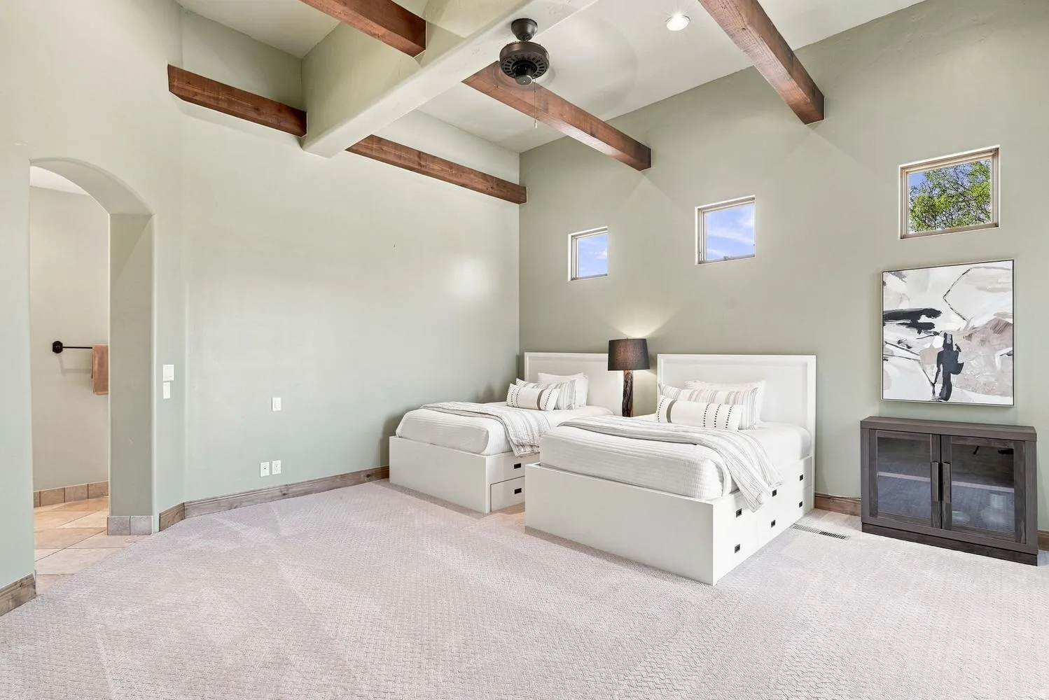 Vaulted ceiling with exposed wood beams, recessed lighting, and a ceiling fan