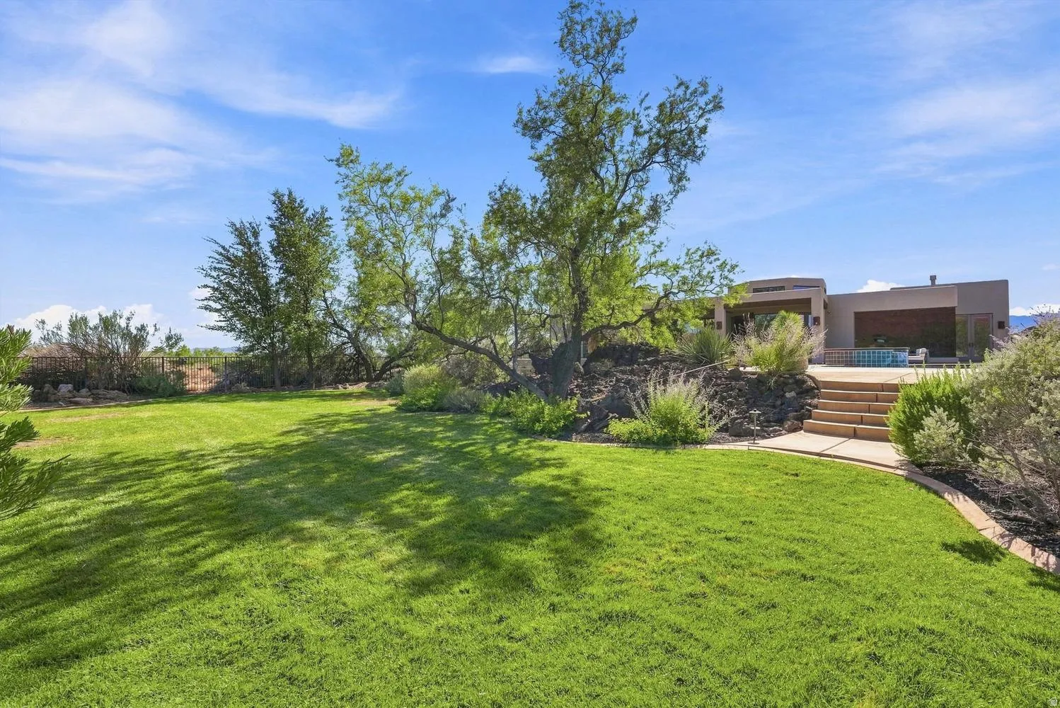 Expansive lawn with surrounding mature trees and landscape plantings