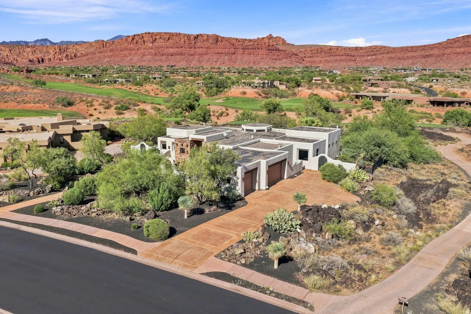 Contemporary property with a flat roofline, stucco exterior, and attached garage