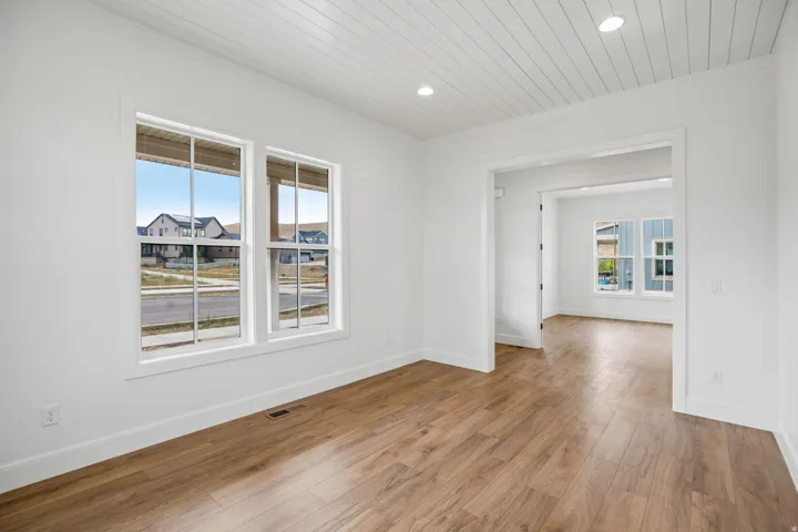 Wood-finish flooring, white walls, and a white shiplap ceiling