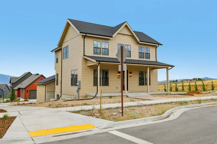 Two-story residence with a covered front porch and multi-pane windows