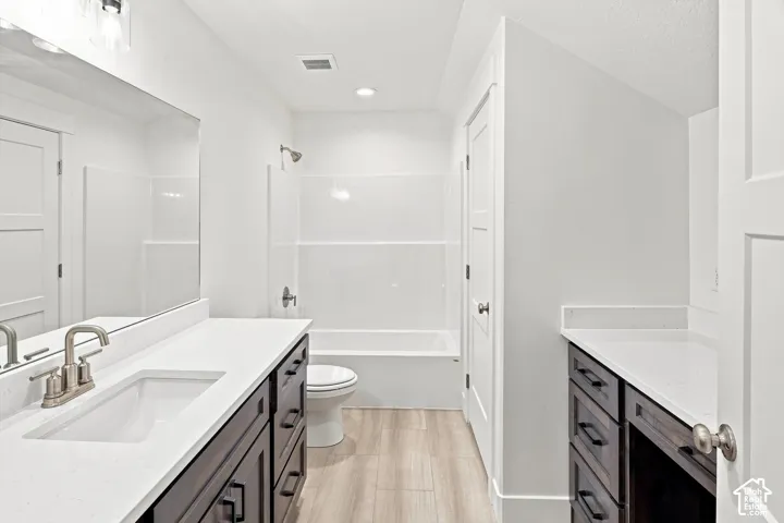 Dual vanity with white countertops, undermount sinks, and dark wood-finish cabinetry