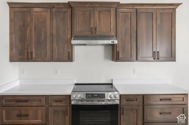 Wood-finish cabinetry with dark hardware