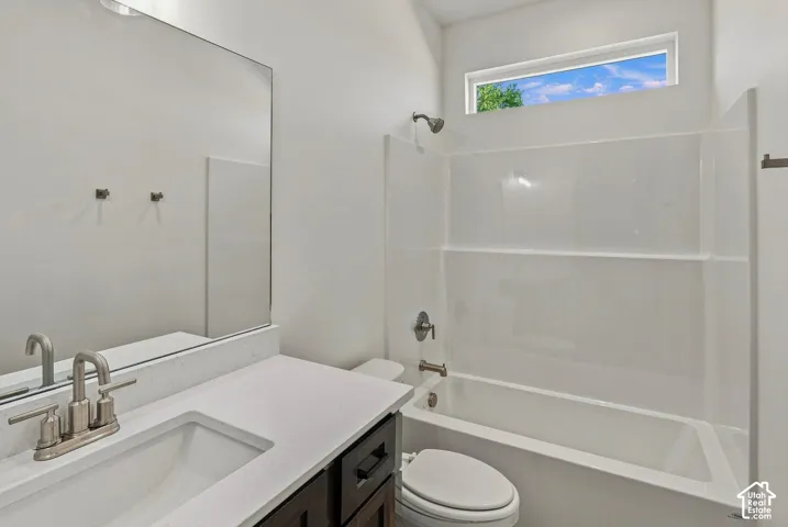 White solid surface vanity with an undermount sink and brushed nickel faucet