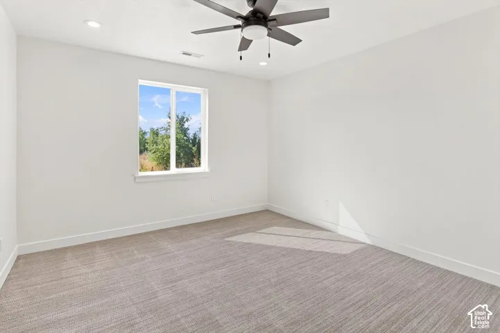 Recessed ceiling lighting, modern ceiling fan, white trim, textured carpeting, and a dual-pane window