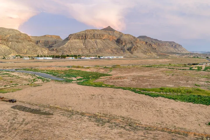 Expansive desert landscape with natural terrain and distant mountain ranges