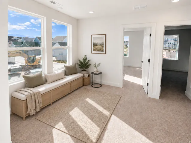 Multiple windows, recessed lighting, neutral carpet flooring, white interior doors, and a built-in window bench with storage compartments