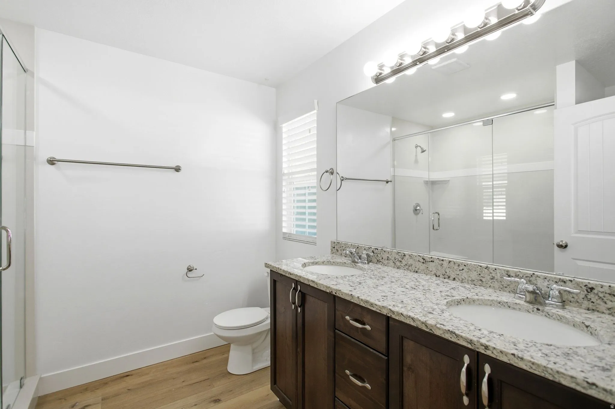 Primary bathroom with dual vanity and extra large shower with upgraded glass.